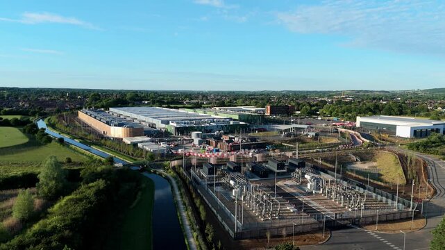 Aerial view of the Google Data Centre in Waltham Cross with a power substation and canal under a blue sky in Cheshunt, England, United Kingdom.