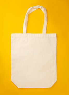 Canvas recycle shopping bag on yellow background