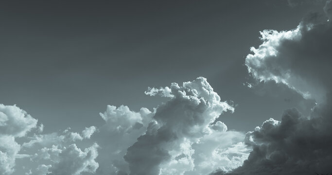 Dark dramatic sky and clouds. Background for death and sad concept. Gray sky and fluffy white clouds. Thunder and storm sky. Sad and moody sky. Nature background. Dead abstract background. Cloudscape.