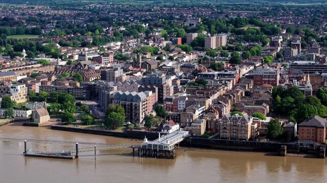 Aerial view of the historic town and waterfront along the River Thames with residential buildings and lush greenery in Gravesend, England, United Kingdom.