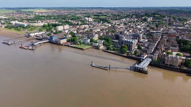 Aerial view of the historic town of Gravesend featuring the waterfront, piers, and residential buildings along the River Thames in Gravesend, England, United Kingdom.