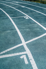 Fototapeta premium Stadium Athletic Running Track Lane Markings and Synthetic Surface Texture