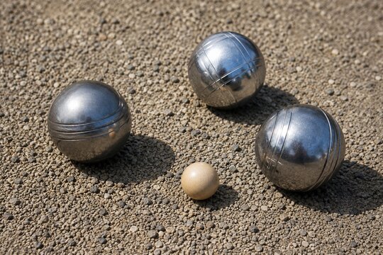 Petanque balls and wooden jack on gravel playing field