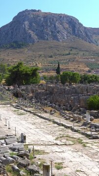 Ancient Corinth ruins with Acrocorinth hill in the background