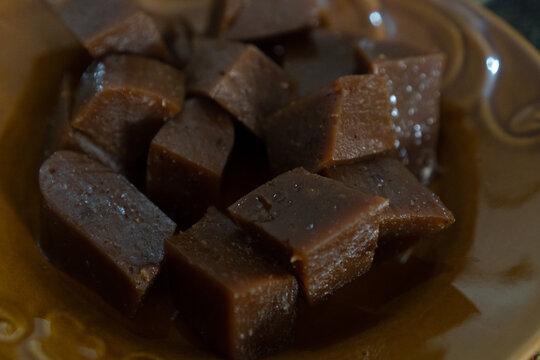 Stack of unwrapped traditional Indonesian sticky sweet dodol on a glass plate.