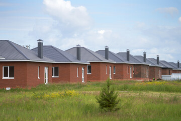 Economy-class suburban construction. A cottage community of simple rectangular brick houses with hipped roofs. © ROMAN DZIUBALO