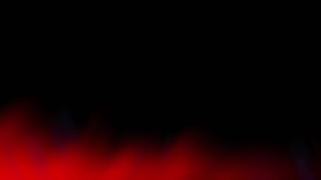 Abstract video showing a black background with red smoke and soft glow creating a dramatic atmospheric gradient