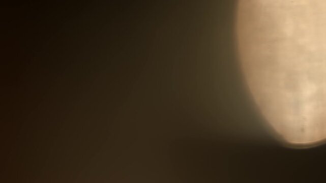 Shimmering Bokeh Real Organic Lens Flare Texture on Black Background. Use blend mode screen, add, overlay on footage for graphic texture. 4K.