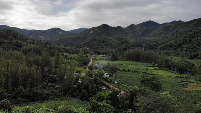 Aerial drone footage of a calm mountains and clouds. Ideal for nature, travel, environment, tropical forest, and cinematic landscape projects.