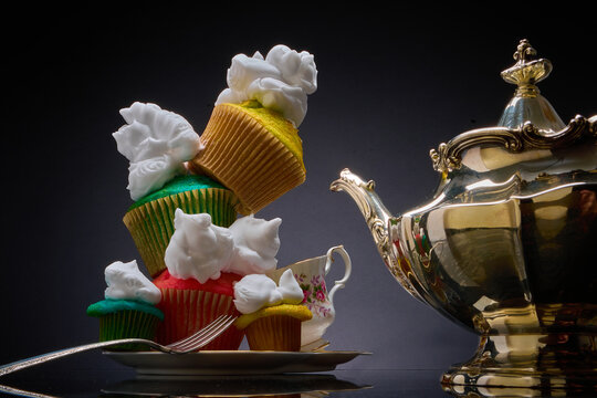 Teetering, colorful, cupcakes, whipped cream & teacup