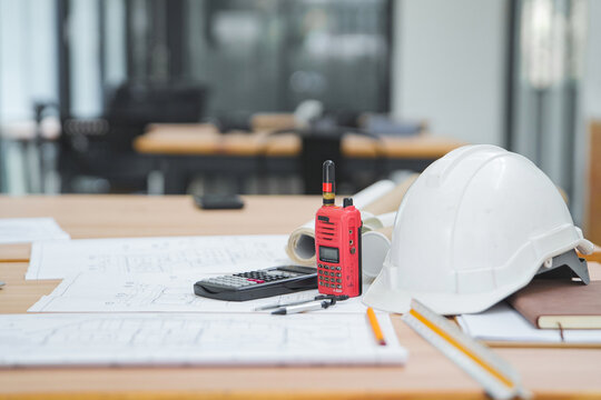 Construction Tools and Equipment on a Desk with Blueprints and a