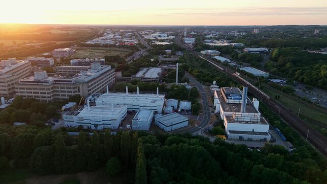 Aerial view of the GSK Stevenage research and development campus with industrial buildings and laboratory facilities at sunset Stevenage, England, United Kingdom.