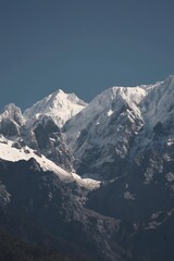 Fototapeta premium Snow-Capped Mountain Peaks Above Rocky Alpine Slopes