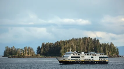 Small expedition cruiseship cruise ship liner National Geographic Venture sailing cruising Alaska Inside Passage with breathtaking Last Frontier mountain and Fjord nature landscape scenery © Tamme Wichmann