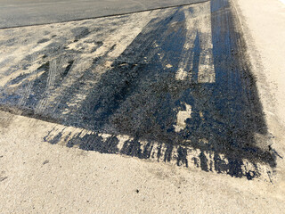 Fototapeta premium Fresh asphalt shows wear and faded markings