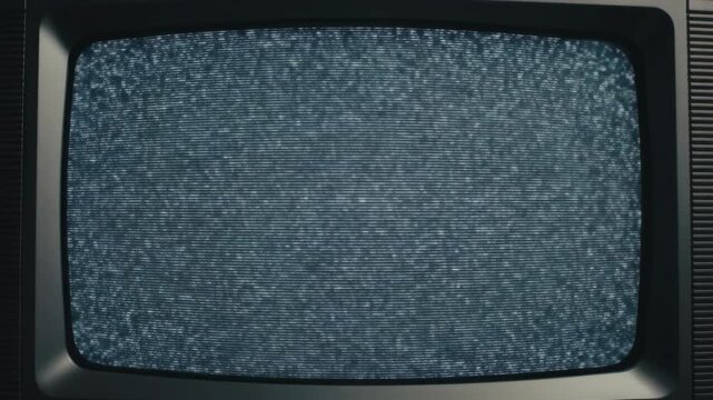Dark screen of a vintage television with a blank, reflective glass surface and textured frame
