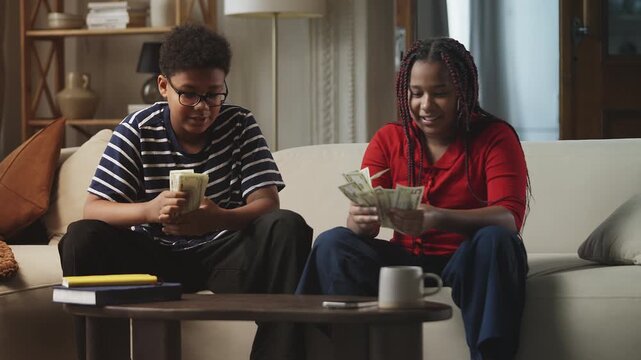 Children counting money and giving each other a high five, financial literacy