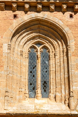 Gothic-Mudejar Lancet Window with Stone Tracery on the Facade of the Church of San Andres in Aguilar de Campos, Valladolid, Castilla y Leon, Spain, Decorated with Carved Modillions from the 14th & 15t © Nandi Estévez