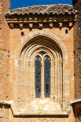 Gothic-Mudejar Architectural Detail of a Lancet Window with Tracery and Sculpted Modillions on the Chevet of the Church of San Andres in Aguilar de Campos, Valladolid, Castilla y Leon, Spain © Nandi Estévez