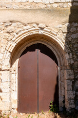 Fototapeta premium Architectural view of the 13th-century Cistercian portal connecting the former cloister with the church at the Monastery of Santa Maria de Palazuelos in Corcos del Valle, Valladolid, Castilla y Leon