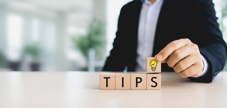 Quick Tips for Smart Solutions. A lightbulb icon block and wooden cubes spelling &ldquo;TIPS". Simple advice, smart ideas and practical guidance and daily work, advice and idea for business, advertising.