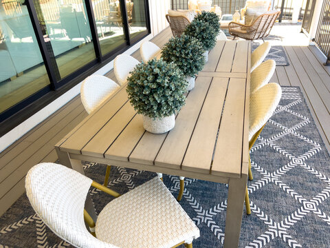 Outdoor dining table with chairs and centerpiece decor