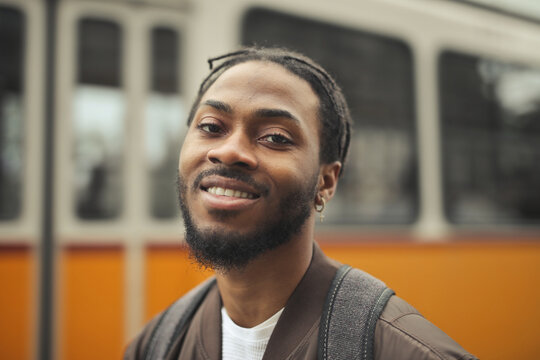 Friendly Black man smiles at the camera outdoors