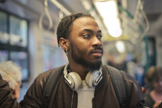 Young man with headphones riding on the train