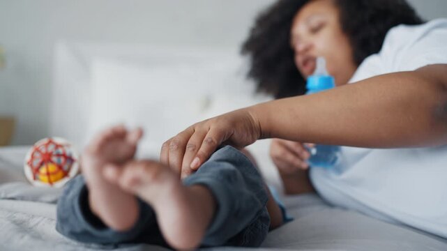 Healthy bottle-fed infant and calm mother, childhood and parenting, mom and son. African american woman enjoying time with her little child, rest after feeding, enjoy motherhood, adopted children