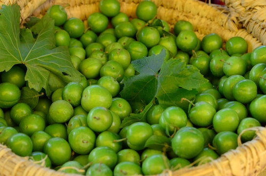 Green Plums in a Woven Basket