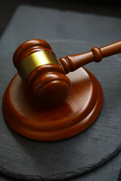 Closeup of Wooden Gavel on Slate Surface Representing Justice and Law Concepts