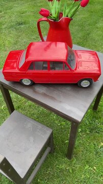 Vintage Red Car on Table with Tulips