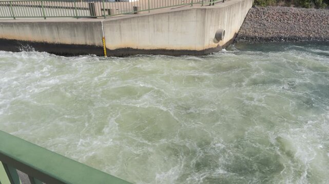 Turbulent water flows out concrete channel at Ash River Outfall