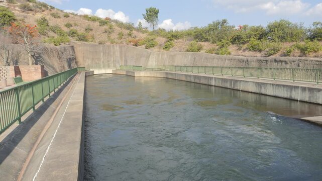 Wide view of water flowing through rectangular weir from Trans Caledon Tunnel at Ash River Outfall