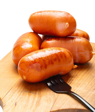 Appetizing grilled sausages on a cutting board close-up