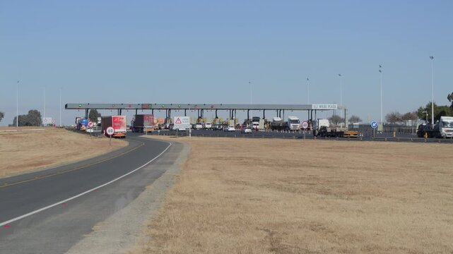 Wide view: trucks and traffic pass through Wilge Toll Plaza on N3 highway