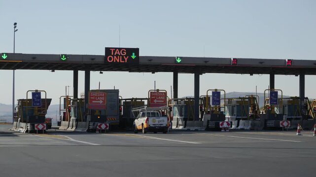Rear view of traffic passing through express lane at de Hoek Toll Plaza