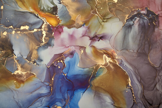 Abstract fluid art background with organic ink textures and subtle gold accents.