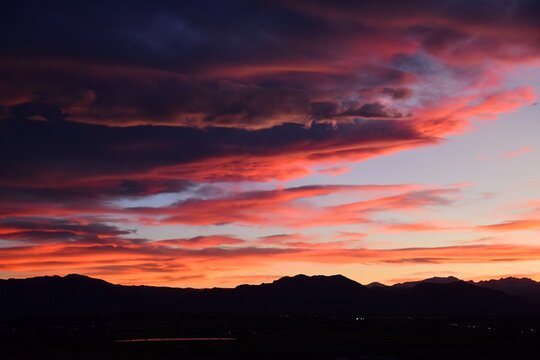 dramatic summer sunset over stearns lake and the front range of the colorado rocky mountains as seen from broomfield, colorado