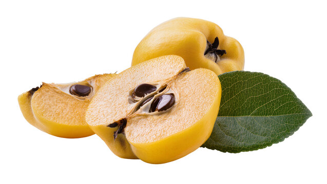 Whole and halved yellow quinces with seeds and green leaf