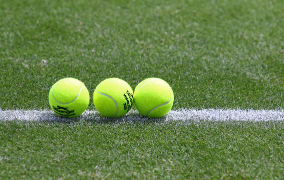 Yellow tennis balls Slazenger Wimbledon 2026 on the green grass lawn of Rot Weiss Tennis Club in Berlin during the WTA 500 Berlin Tennis Open tournament