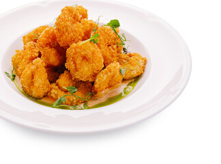 Fototapeta premium Delicious deep fried breaded prawns on white plate. Premium seafood appetizer served with savory dipping sauce.