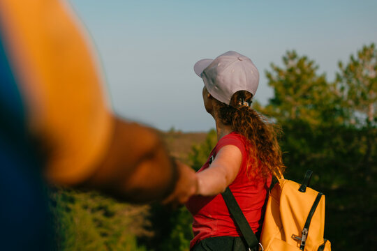 Couple holding hands exploring nature on a journey