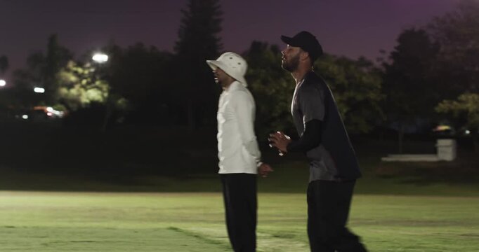 African american man pitcher juggling then pitching, batsman hitting running single base