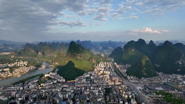 Yangshuo, China :Panoramic footage of a dramatic sunset over Yangshuo town by Li river surrounded by its dramatic karst peaks landscape near Guilin in southern China