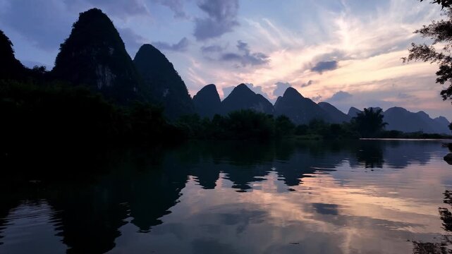 Yangshuo, China : Panoramic footage of dramatic sunset over Yulong river in Yangshuo, southern China with reflection of karst mountain peak in the water