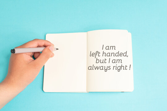 Left handed but I am always right standing on notebook, writing with left hand, pen and table, lefty concept, handwriting a message