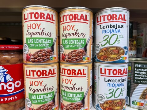 Calvia, Spain - June 07, 2026: Litoral canned lentils with labels in Spanish, displayed on a grocery store shelf alongside other canned goods
