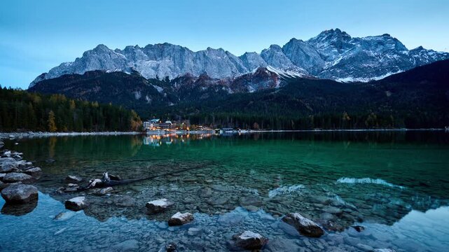 Timelapse dusk view of Zugspitze mountain and Eibsee which is a lake near Garmisch-Partenkirchen