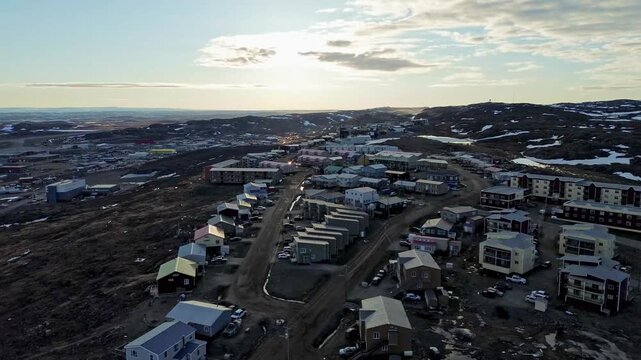 High-altitude drone perspective showcasing the modern residential layouts and modular homes built within the high Plateau neighborhood section of Iqaluit, Nunavut.